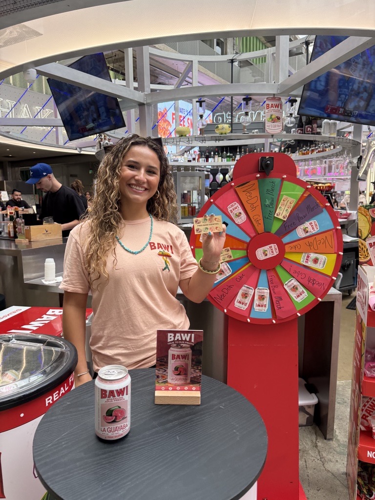 abby antoun introducing Bawi at POST Houston beside the promotional wheel